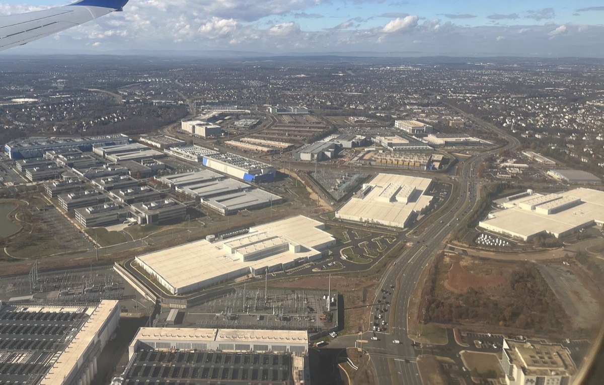 Aerial view of large, flat-roofed data-center buildings among roads and other commercial buildings near Ashburn, Virginia