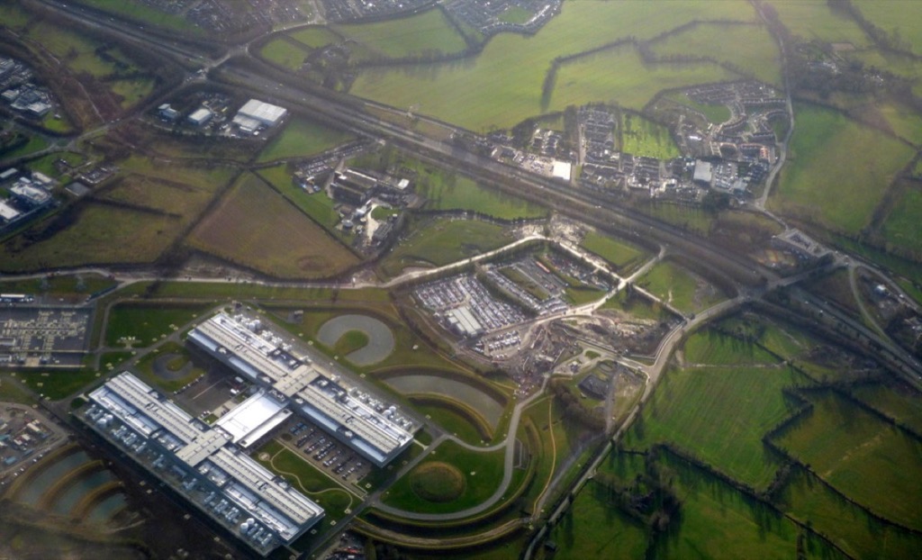Aerial view of two long data-center halls surrounded by green fields at Clonee, County Meath